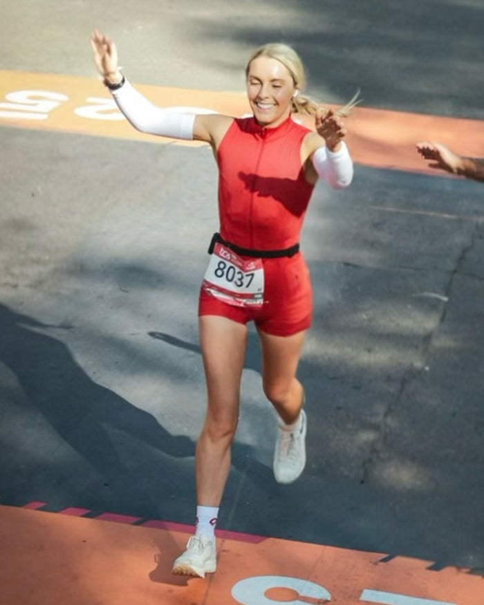 woman crossing the finish line of a race