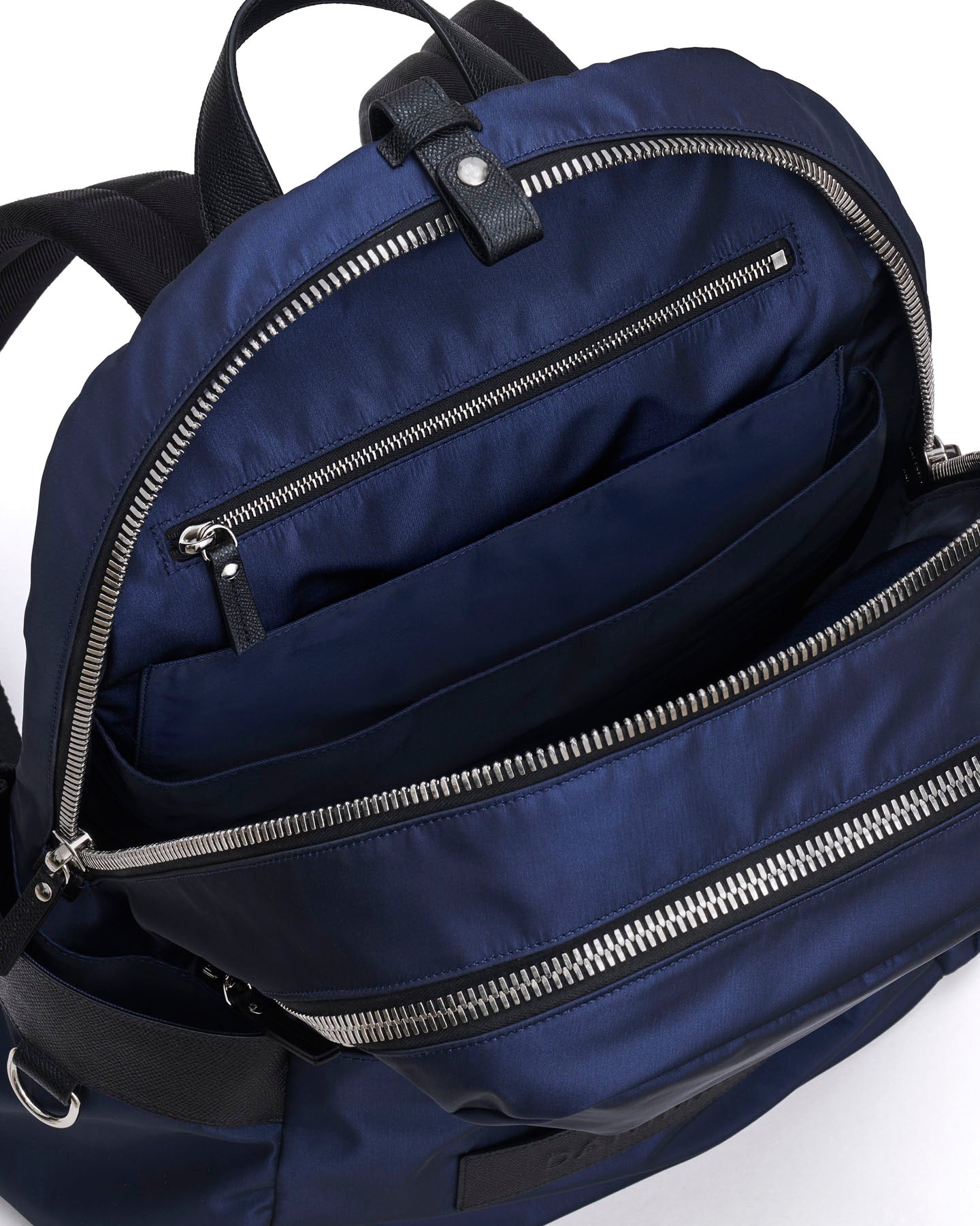 Navy blue backpack with multiple zippers on a white background