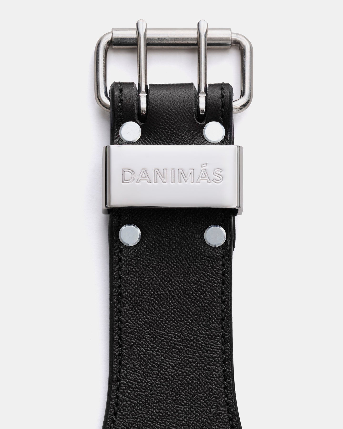 Black leather strap with silver buckle and 'Danimós' branding on a white background