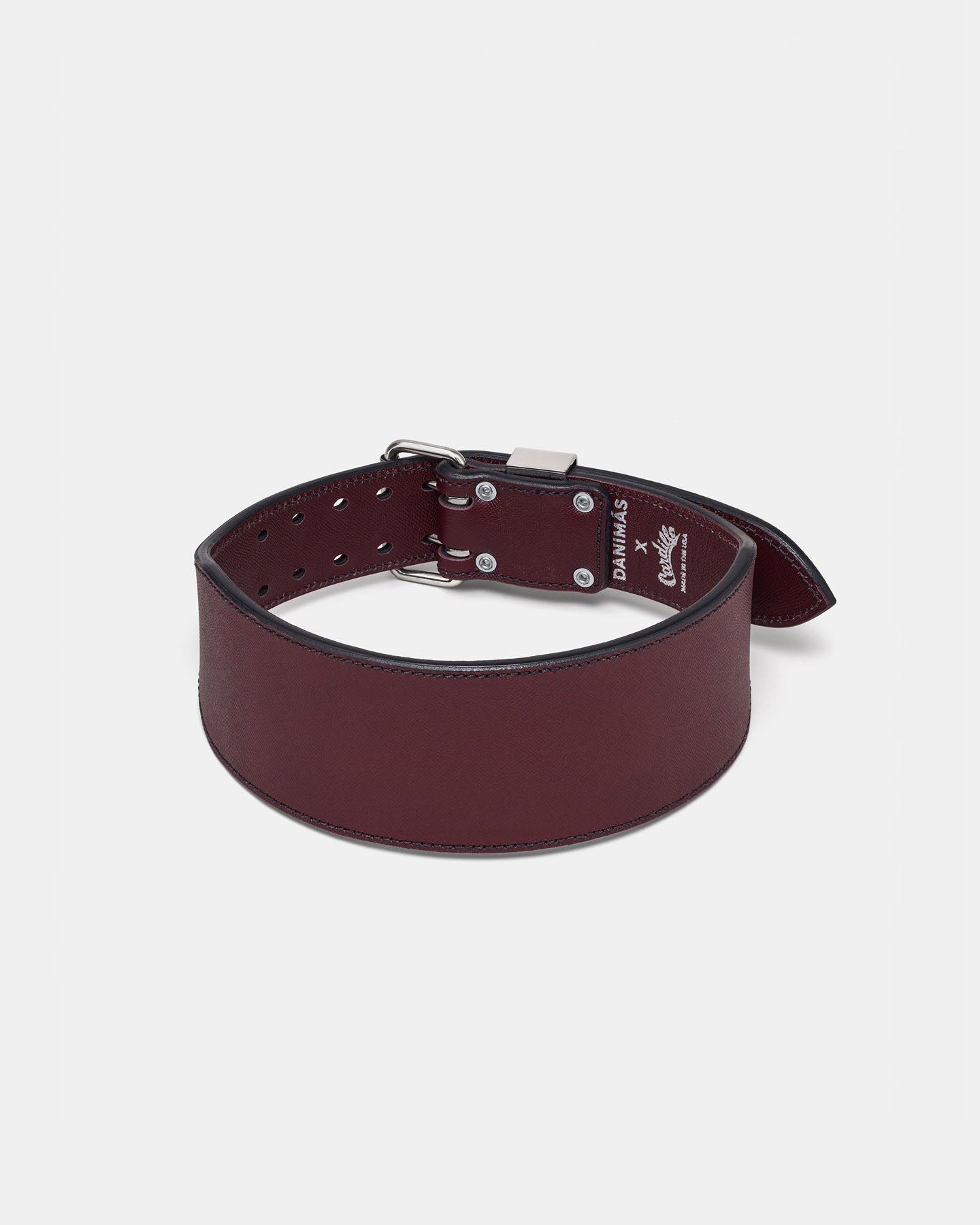 Burgundy leather belt with silver buckle on a light gray background