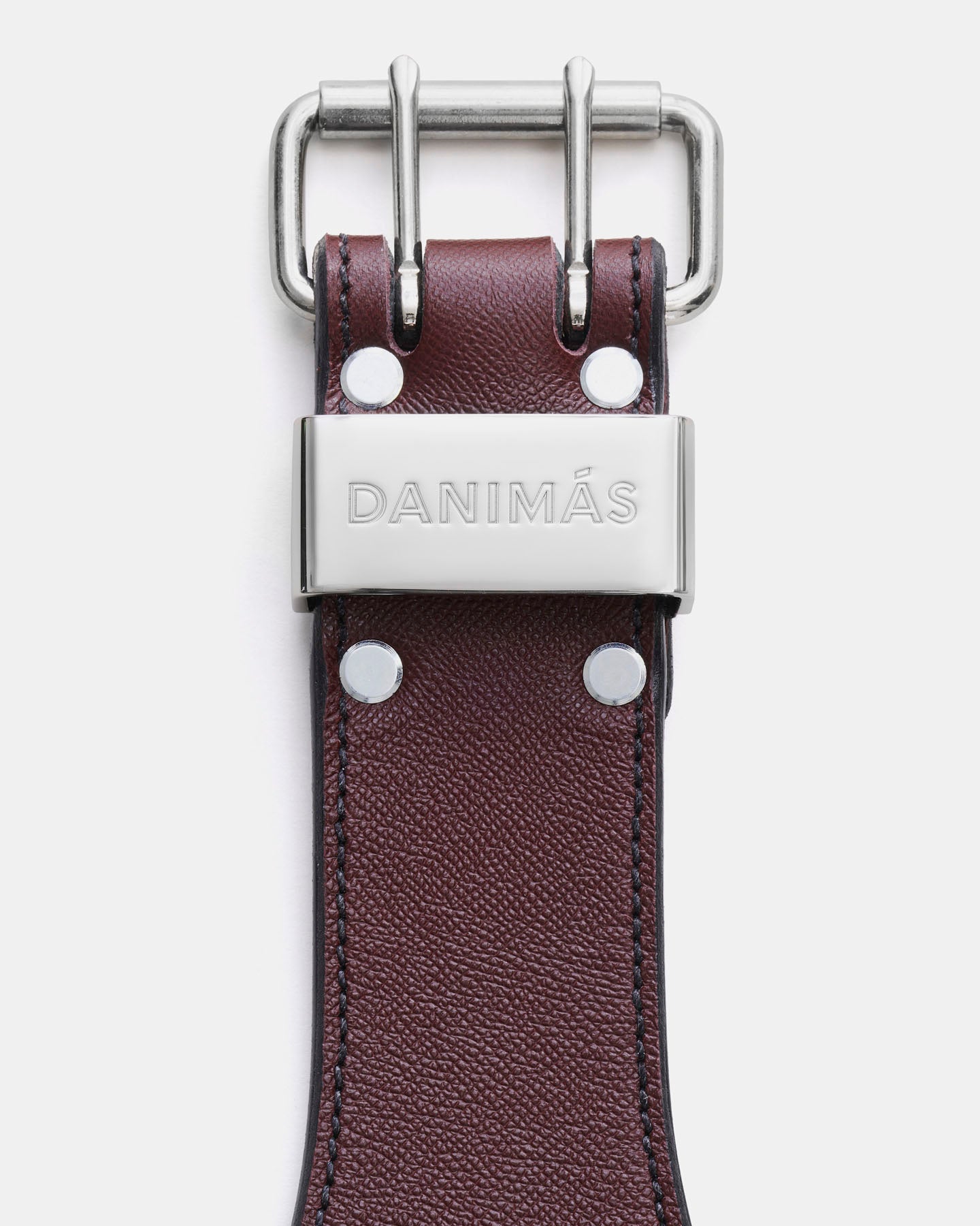 Burgundy leather strap with silver buckle and 'Danimós' branding on a white background