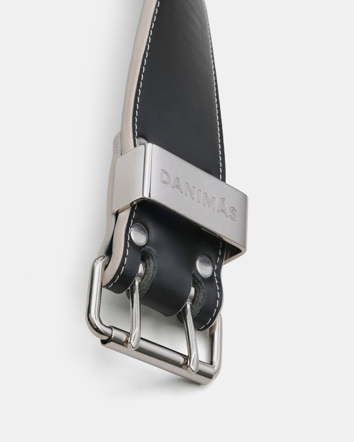 Black leather belt with silver buckle on a white background