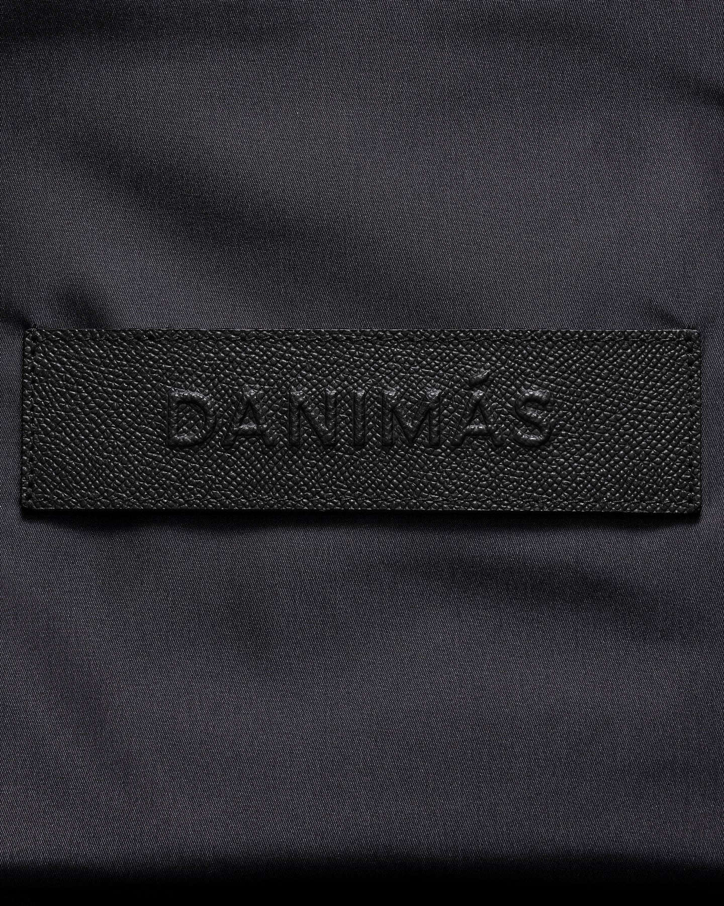 Black patch with 'DANIMAS' branding on a dark background